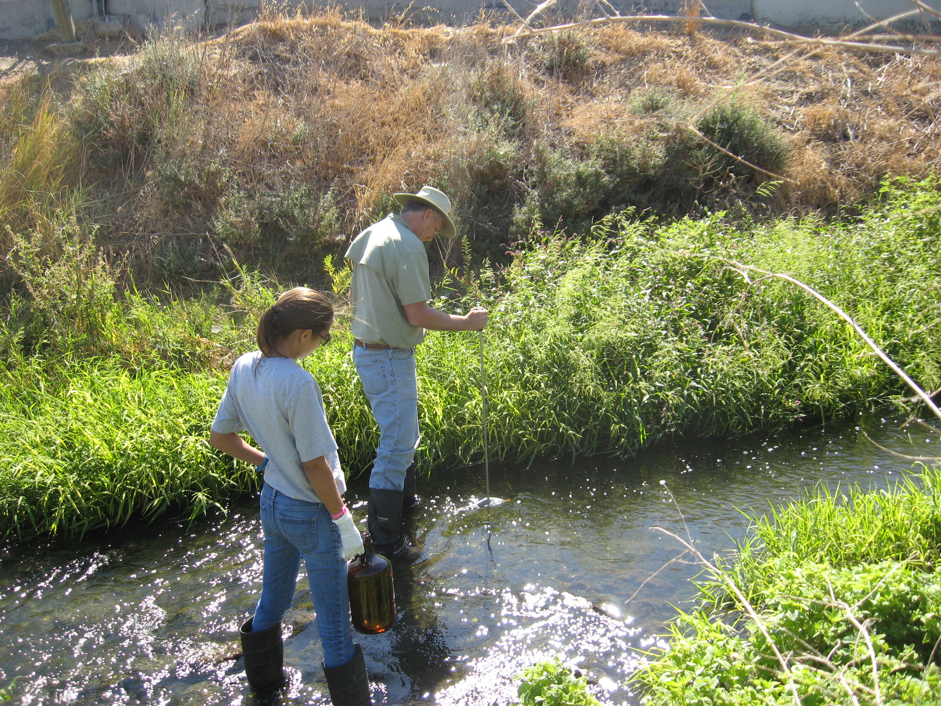 HydroFocus personnel measure surface water flow and collect water-quality samples.
